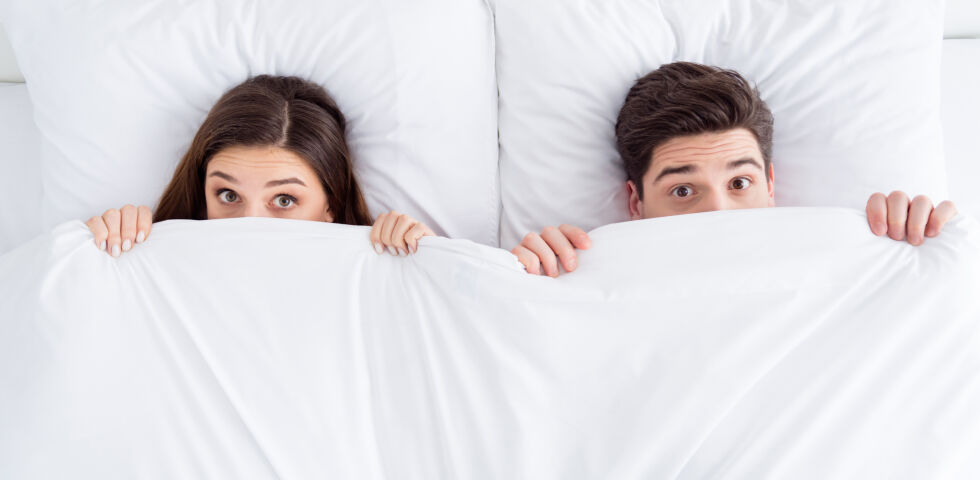 Frau und Mann liegen im Bett - © Shutterstock